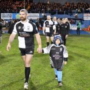 Kyle Amor leads out Cumbria RL to play Jamaica last year