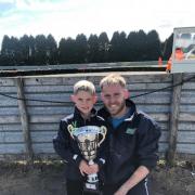 Eight-year-old Oliver Sibbald is continuing to defy expectations as he ends the season with 14 podium finishes from 18 races. Pictured with dad Matthew Sibbald