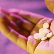 A  photo of a hand with pills. PA Photo/ Generic