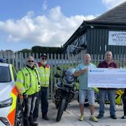 Members of the village hall committee hand over the cheque