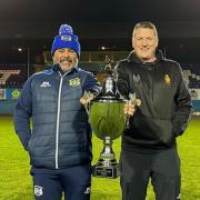 Workington Town head coach Anthony Murray and Whitehaven head coach Jonty Gorley holding the Ike Southward Memorial Trophy