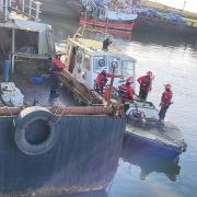 The team worked to help the boat which was 'taking on water'.