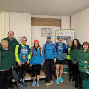 Andrew Robinson (second left) and Sam Ayres (fifth from left) with food bank volunteers and runners and some of the donations