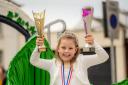 Lyla Markha, the Flimby Ivy Queen is delighted with the trophies won at Maryport carnival