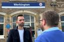 Josh MacAlister talking to staff outside of Workington train station