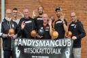 Members of Andy's Man Club with representatives from the Uppies and Downies charity committee