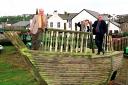 Bill Cameron chairman of maryport partnership, Noel Butters chief executive of MDL and David Martin regeneration manager stand abourd the shipwreck that will be part of the childrens playground being built.pic tom kay    copy thompson
