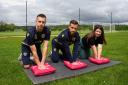 Oxford United players Billy Boden (left) and Joe Bennett (right) learning CPR