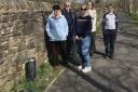 Laureates residents Dot and Mel Gould, Clare Davidson, Alice and Daniel Bishop on Joe's Walk, beside one of the 29 lighting bollards that have been vandalised