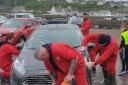 Volunteers wash the vehicles