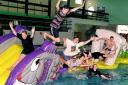 Staff at  Workington swimming pool try out the new inflatable.