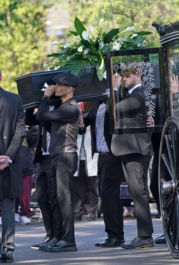 Times and Star: Max George and Jay McGuiness of The Wanted carry the coffin at the funeral of their bandmate. (PA)