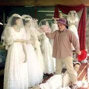 Best man Dave Richards with his Spring Collection of wedding dresses at Age Conern's Charity Shop Workington. pic Jim davis