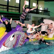 Staff at  Workington swimming pool try out the new inflatable.