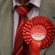 A man wearing a red Labour rosette