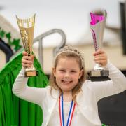 Lyla Markha, the Flimby Ivy Queen is delighted with the trophies won at Maryport carnival