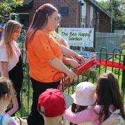 Mayor Beth Dixon cuts the ribbon for the new garden