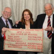 Former Labour MPs for Workington Sir Tony Cunningham, Baroness Sue Hayman and Lord Dale Campbell-Savours, with a banner embroidered by Workington Labour Party member nonagenarian JMercia Haughan.