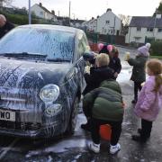 Children practicing for the charity car wash.