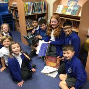 Children from different year groups read together