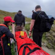 Coniston Mountain Rescue team and fellow walkers stretcher the man down Blag Crag