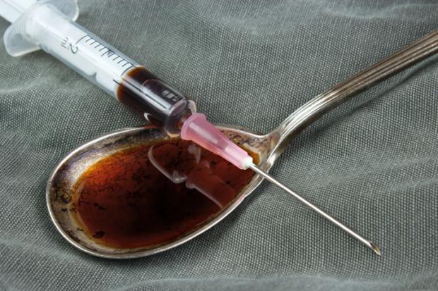 Times and Star: GENERIC PICTURE --- Drug syringe and cooked heroin on spoon